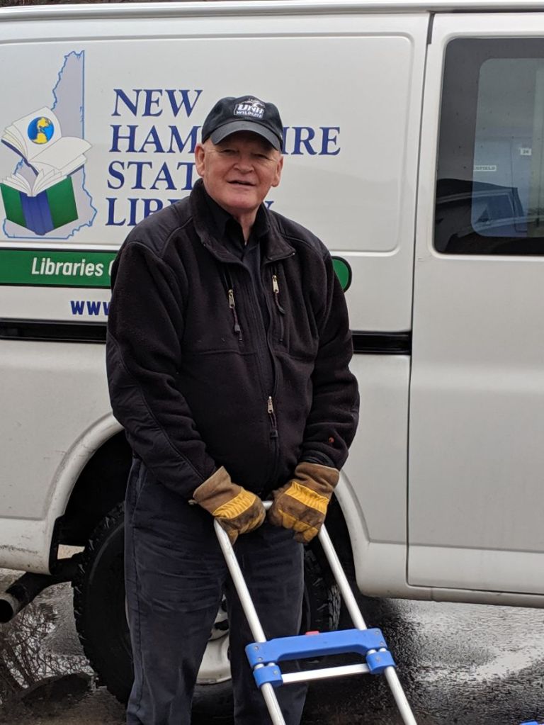 David, our Inter-Library Loan delivery driver, standing beside the New Hampshire State Library courier van